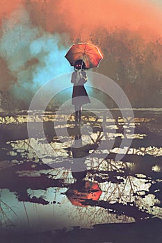 Mysterious woman holds umbrella standing in a puddle