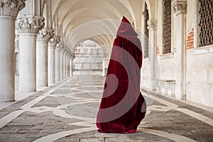 Mysterious woman in red cloak photo