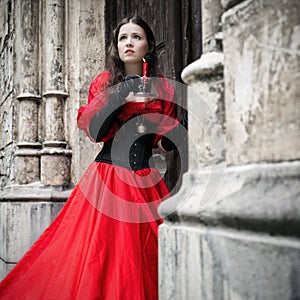 Mysterious woman in red Victorian dress