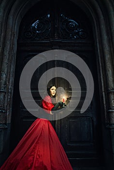 Mysterious woman in a red Victorian dress