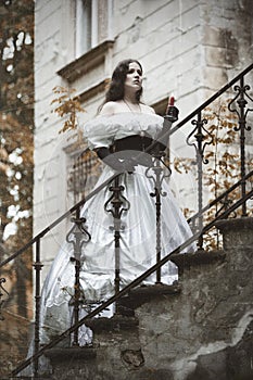 Mysterious woman in a white Victorian dress