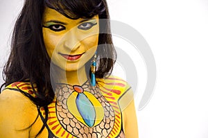 Mysterious yellow bodypainted tribal face of a girl on a white background.