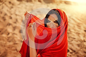 Mystery arabic woman beauty eyes makeup golden mask veil niqab hide face. Fantasy girl art photo oriental fashion model