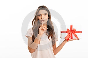 Mystery brunette woman in t-shirt holding gift box