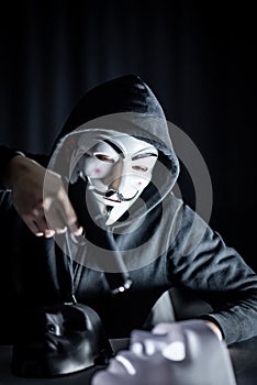 Mystery man holding gun over white mask