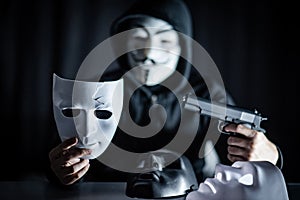 Mystery man shooting gun to white mask