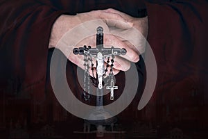 Mystery monk's hands with a cape, crucifix and a black rosary
