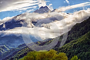 Mystery mountain landscape with dark clouds sunligh