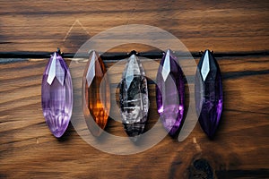 Mystic five small crystals lie on a stone background in the wood, in the style of dark purple and light amber.