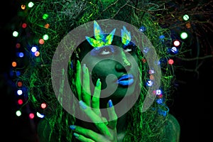 Mystic green dryad in UV fluor black light with Glowing trees on background