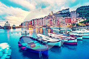 Mystic landscape of the harbor with colorful houses and the boats in Porto Venero, Italy, Liguria in the evening in the light of