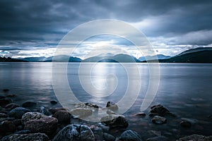 Mystic landscape lake scenery in Scotland: Cloudy sky, sunbeams and mountain range in loch Linnhe