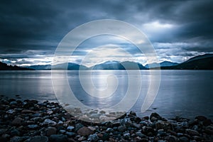 Mystic landscape lake scenery in Scotland: Cloudy sky, sunbeams and mountain range in loch Linnhe