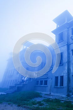 Mystic landscape of old French colonial building in the mist, old abandoned unfinished building of Bokor Casino, Borkor Mountain,