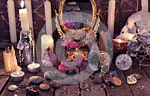 Mystic still life with coffee cup, skull, burning candles and stone runes