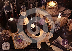 Mystic still life with voodoo doll, the tarot cards, witch books and magic objects