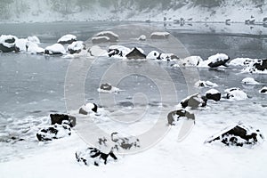 Mystic winter rock garden on the small frozen lake