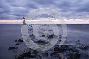 Mystical foggy sea and rocky shore in the evening