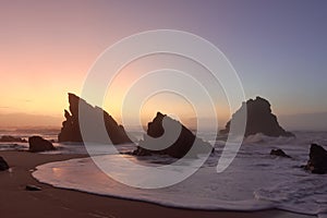 Mystical foggy sunset on the beach Praia da Adraga. Sintra, Portugal