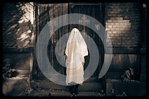 A mystical ghost standing in front of wooden church doors, evoking themes of Halloween, horror and occultism. The eerie image