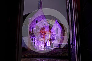 Mystical medieval houses in colorful lights at night