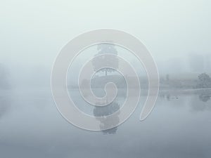 Mystical morning landscape with fog over the lake. Soft focus