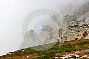Mystical rocky cliffs wrapped in clouds or fog.
