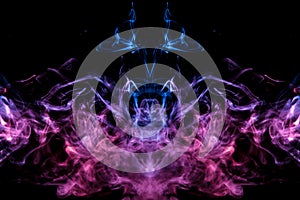 Mystical silhouette of evaporating ghost head smoke on a black background in thin tongues of blue flame highlighted in pink