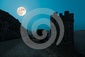 A mystical summer night at the Cabo Tinoso fortress with a full moon. photo