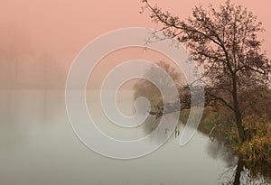 Mystical sunrise in autumn by the pond