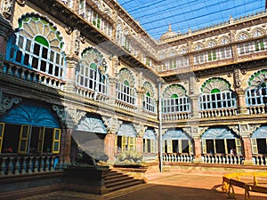 MYSURU MYSORE,KARNATAKA/INDIA- JAN 12 2018:Indian tourists look through to a coutyard within the Royal palace of Mysuru photo