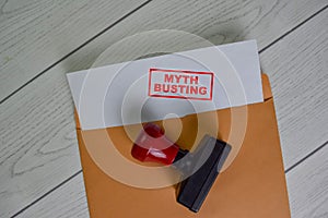 Myth Busting text on document above brown envelope photo