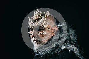 Mythical king of permafrost realm in fur collar isolated on black background. Magical beast with golden reptile skin and photo