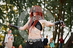 Mythological dancing girl faun on green lawn in public park outdoor art dancing event