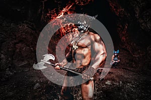 Mythological Minotaur  half bull half man stands in a rock cave in an aggressive stance