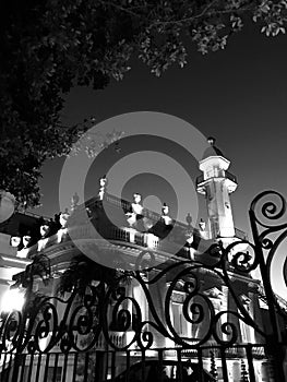 A gate and tree in front of a minaret in Merida, Mexico - MEXICO photo