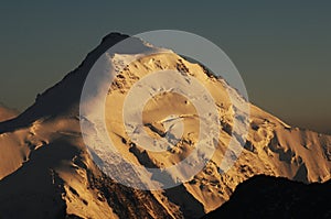 MÃÂ¶nchshÃÂ¼tte: GLobal clima change: Bernese swiss mountain peak with melting glacier at sunset near Grindelwald photo