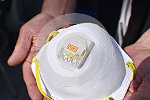 N95 Respirator In Elders Hands Close Up High Quality photo