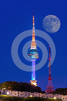 N Seoul Tower with full moon Located on Namsan Mountain in central Seoul,Korea.