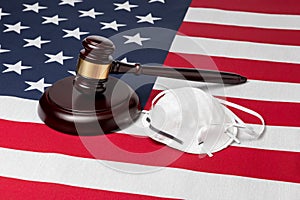 N95 face mask and gavel isolated on United States of America flag