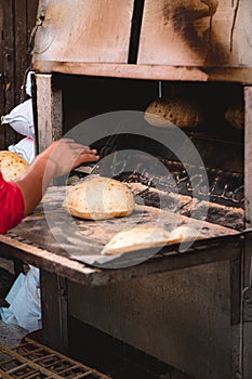 Naan bread being baked on the street of cairo, egypt. Several produced per minute, sold by the street vendors and given away to