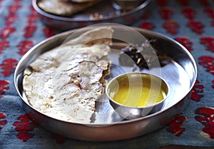 Naan flat bread with daal soup in thali photo