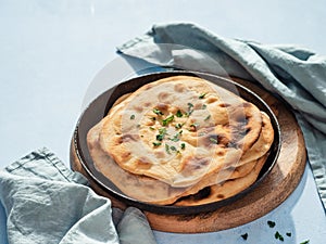 naan flatbread on blue, copy space