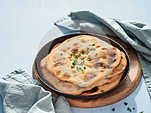 naan flatbread on blue, copy space photo