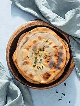 Naan flatbread on blue, copy space, top view photo
