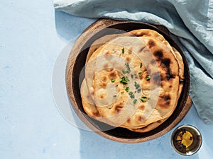 naan flatbread on blue, copy space, top view photo