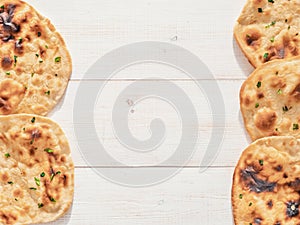 naan flatbread on white wood, copy space, top view