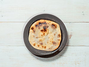 naan flatbread on white wood, copy space, top view photo