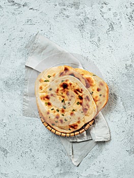 naan flatbreads on gray cement, copyspace vertical