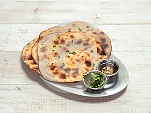 naan flatbreads on white wood, copy space